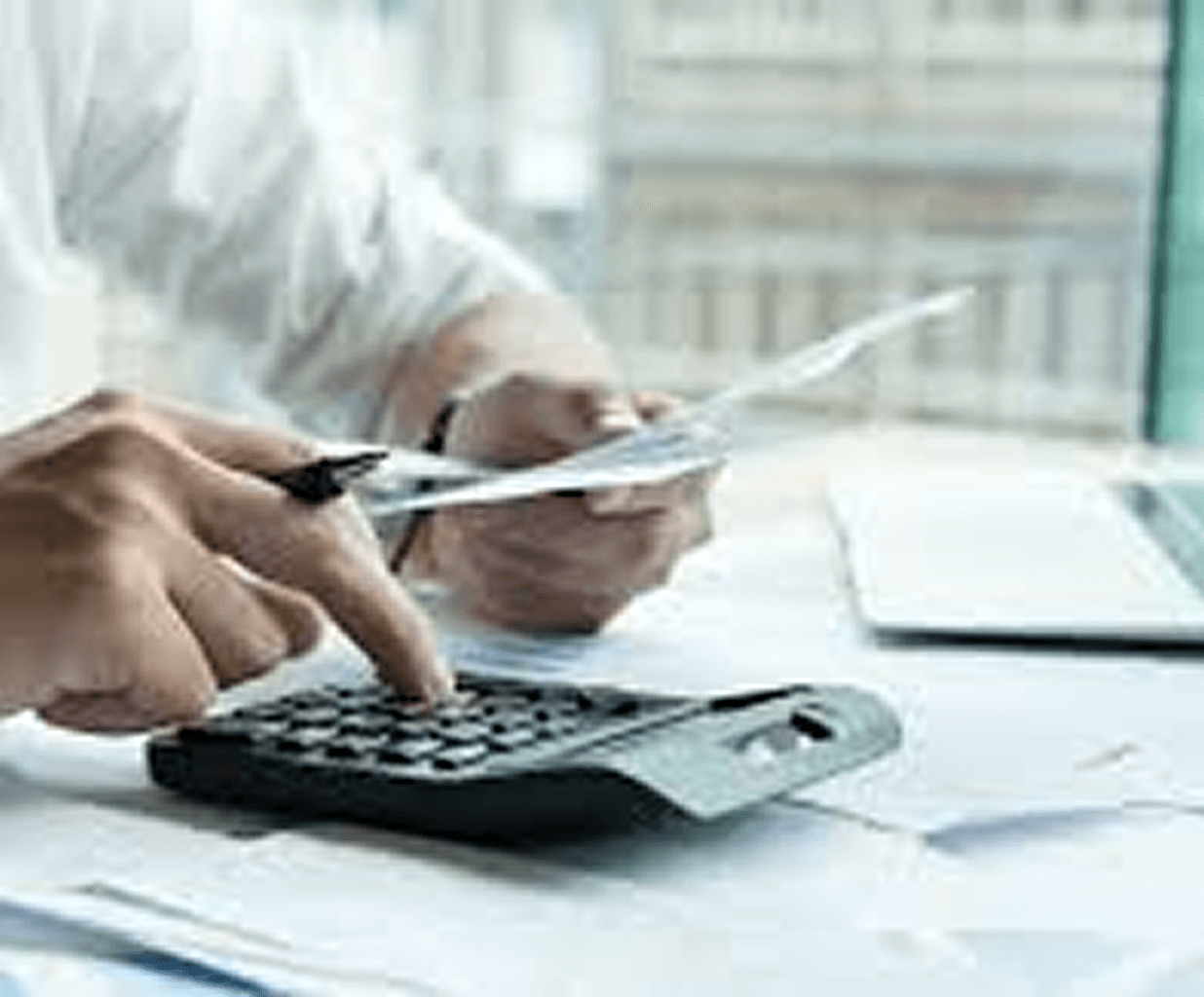 Man using a calculator